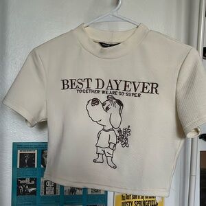cream colored cropped tee with a cute little dog